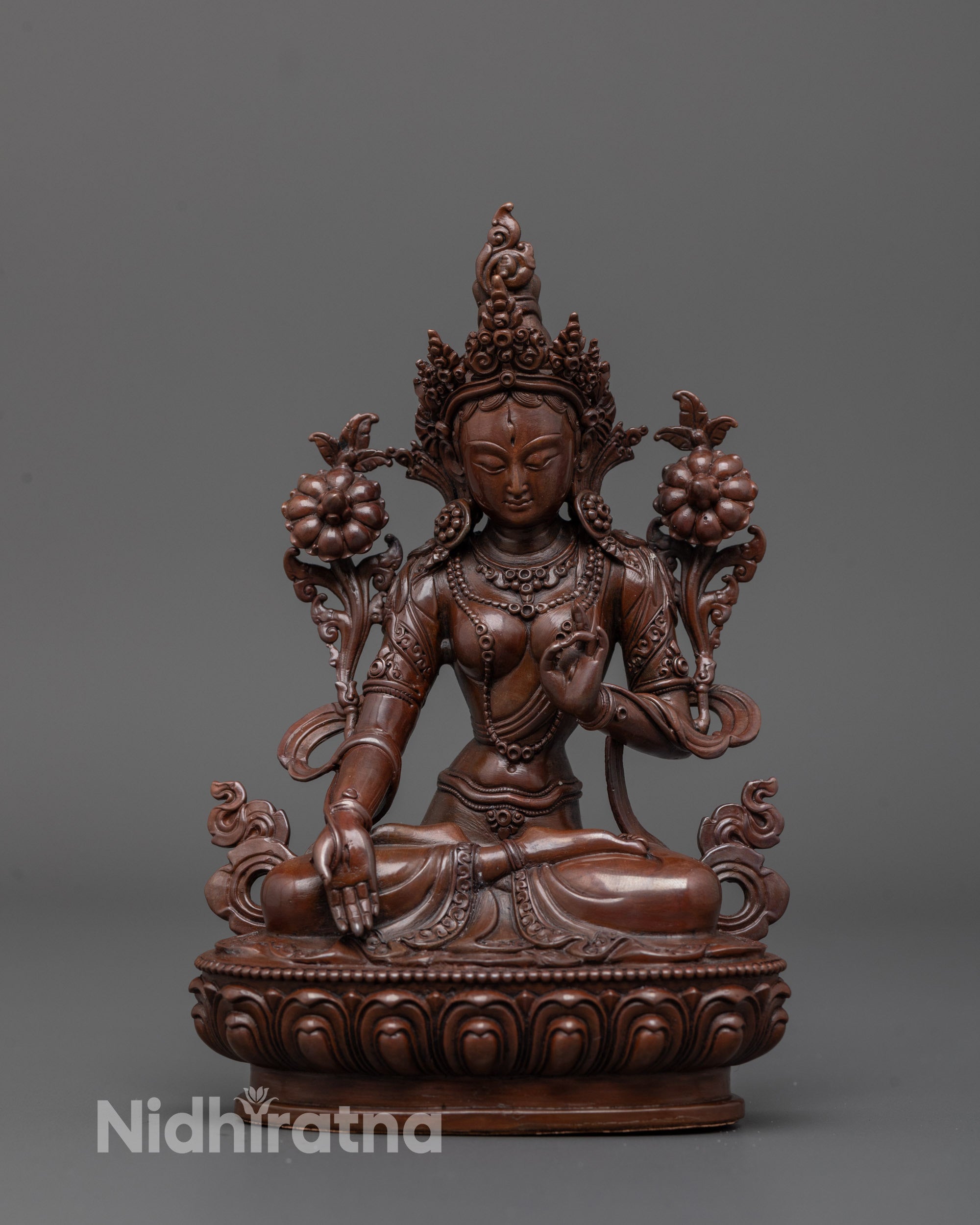 Front view of oxidized White Tara statue seated on lotus with intricate carved robes
