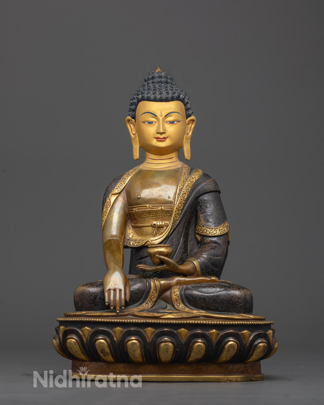 Front view of oxidized copper Shakyamuni Buddha statue with gold-gilded face