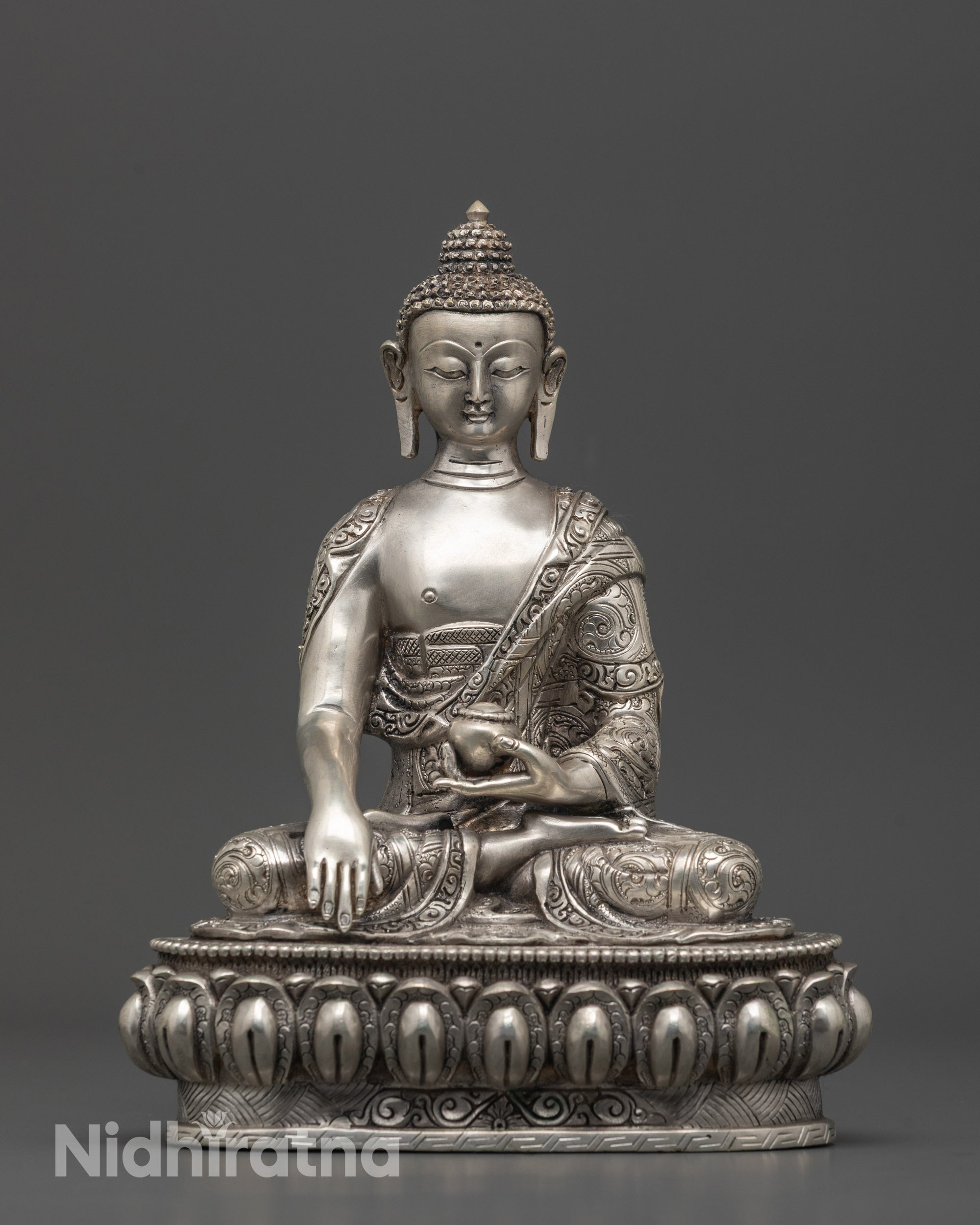 Front view of silver-plated Shakyamuni Buddha Statue seated on lotus base