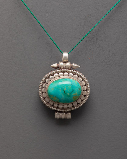 Front view of silver turquoise locket with oval stone, handcrafted by Himalayan artisans