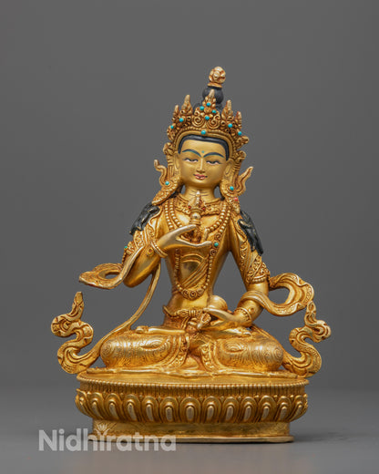 Front view of the Vajrasattva Statue seated on a lotus base while holding a vajra and bell
