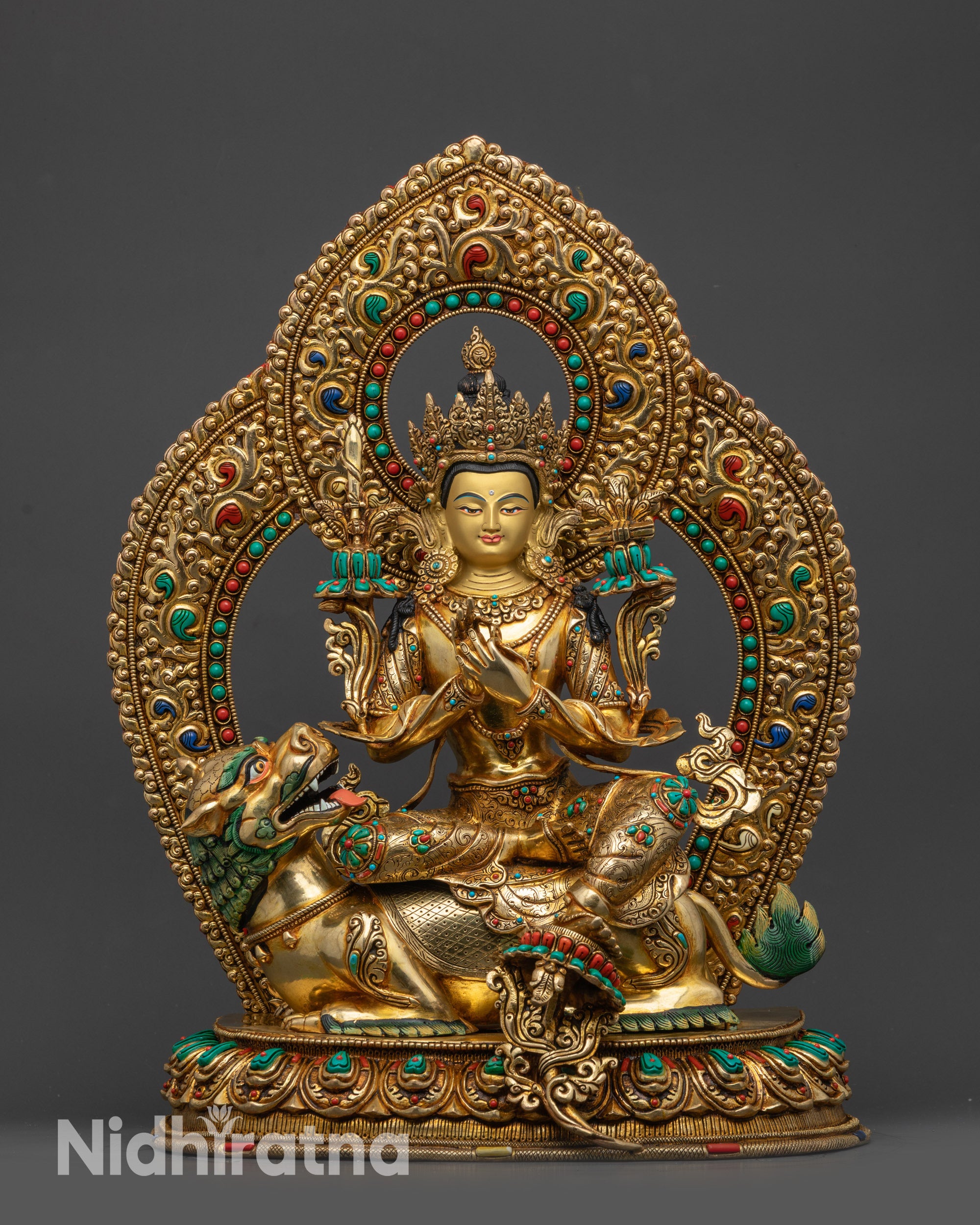Front view of the full Manjushri statue with lotus and snow lion base
