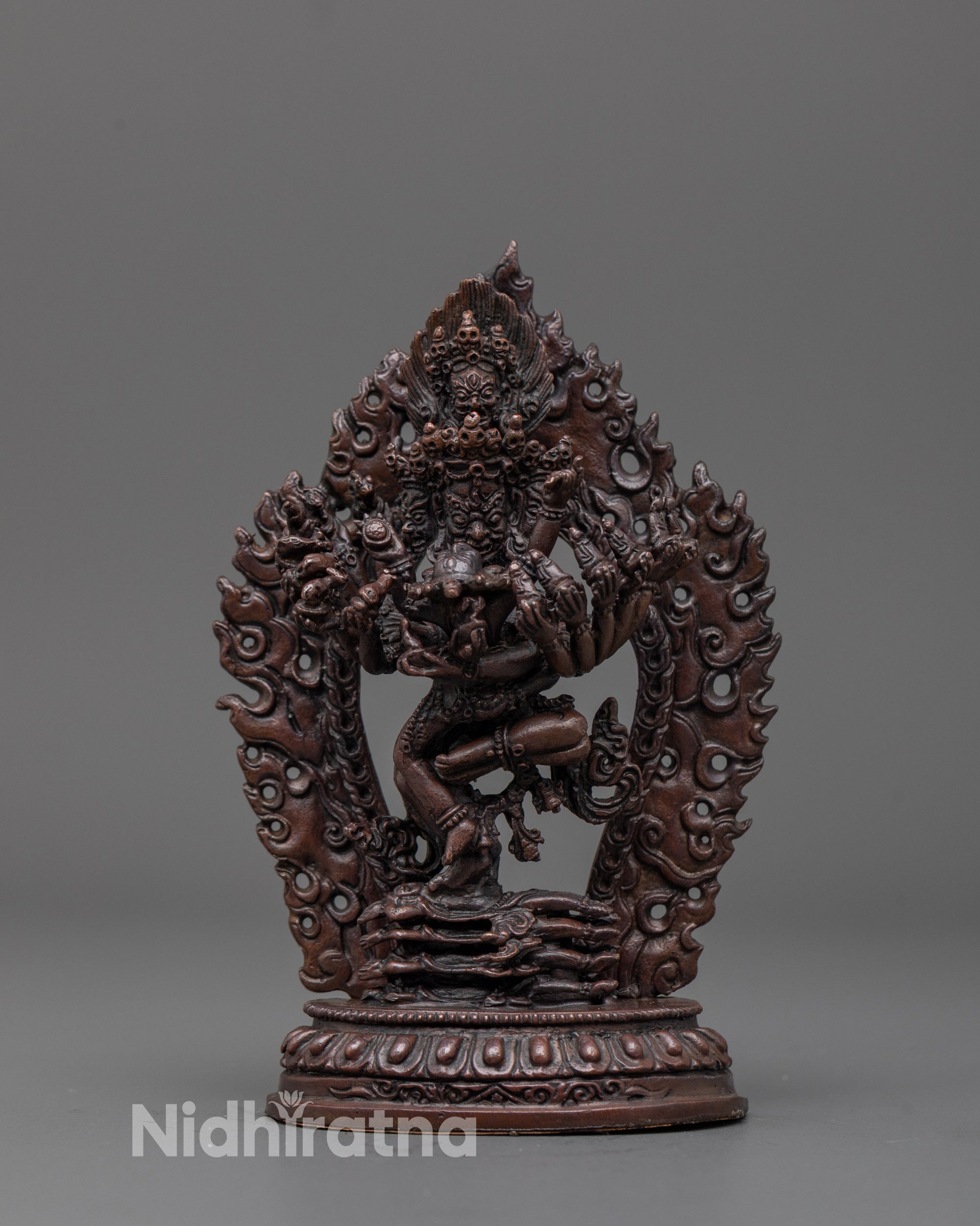 Front view of the hand-carved Hevajra statue standing on multiple subdued figures