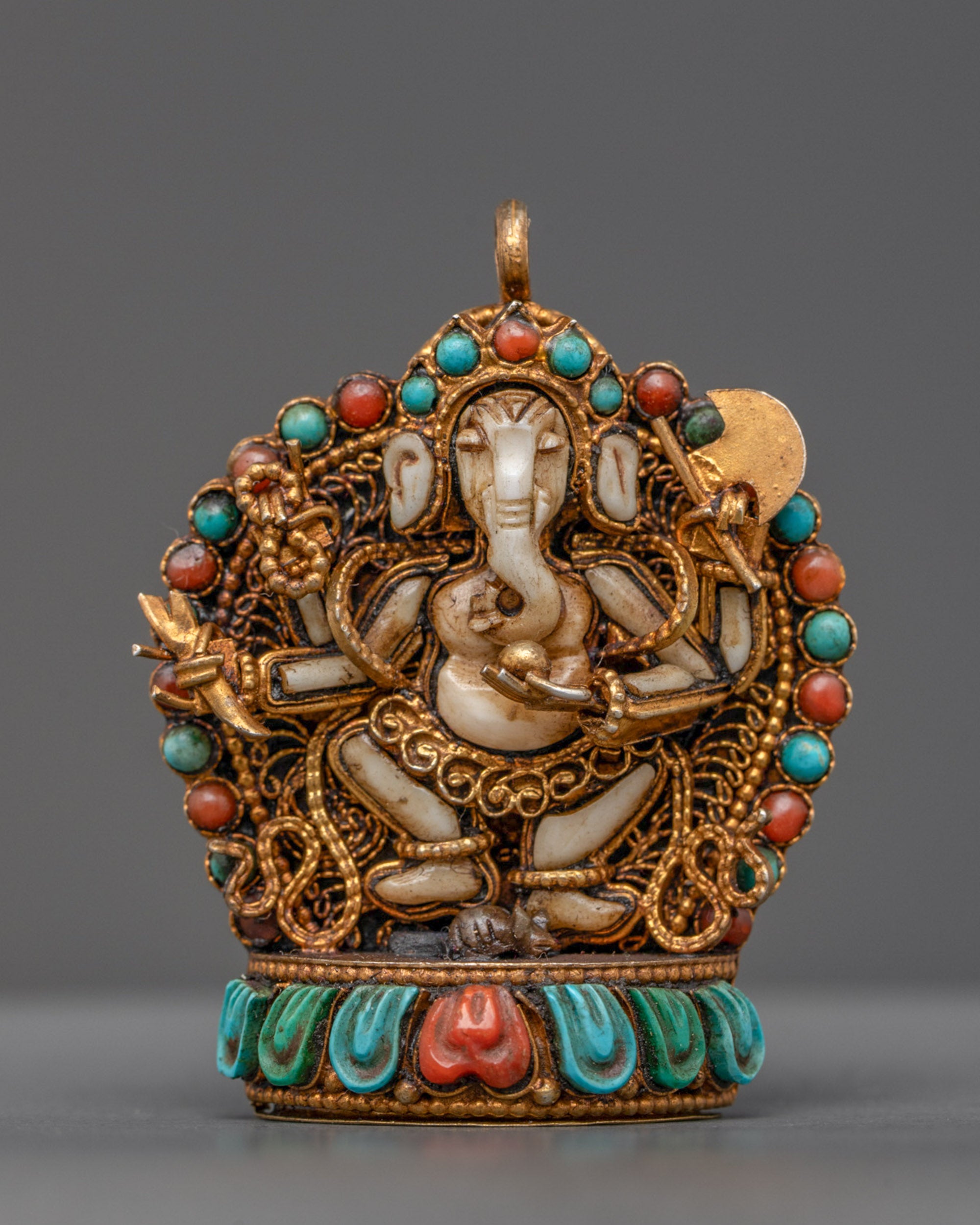 Front view of white stone Ganesh locket with gold-gilded axe, mala, and filigree design