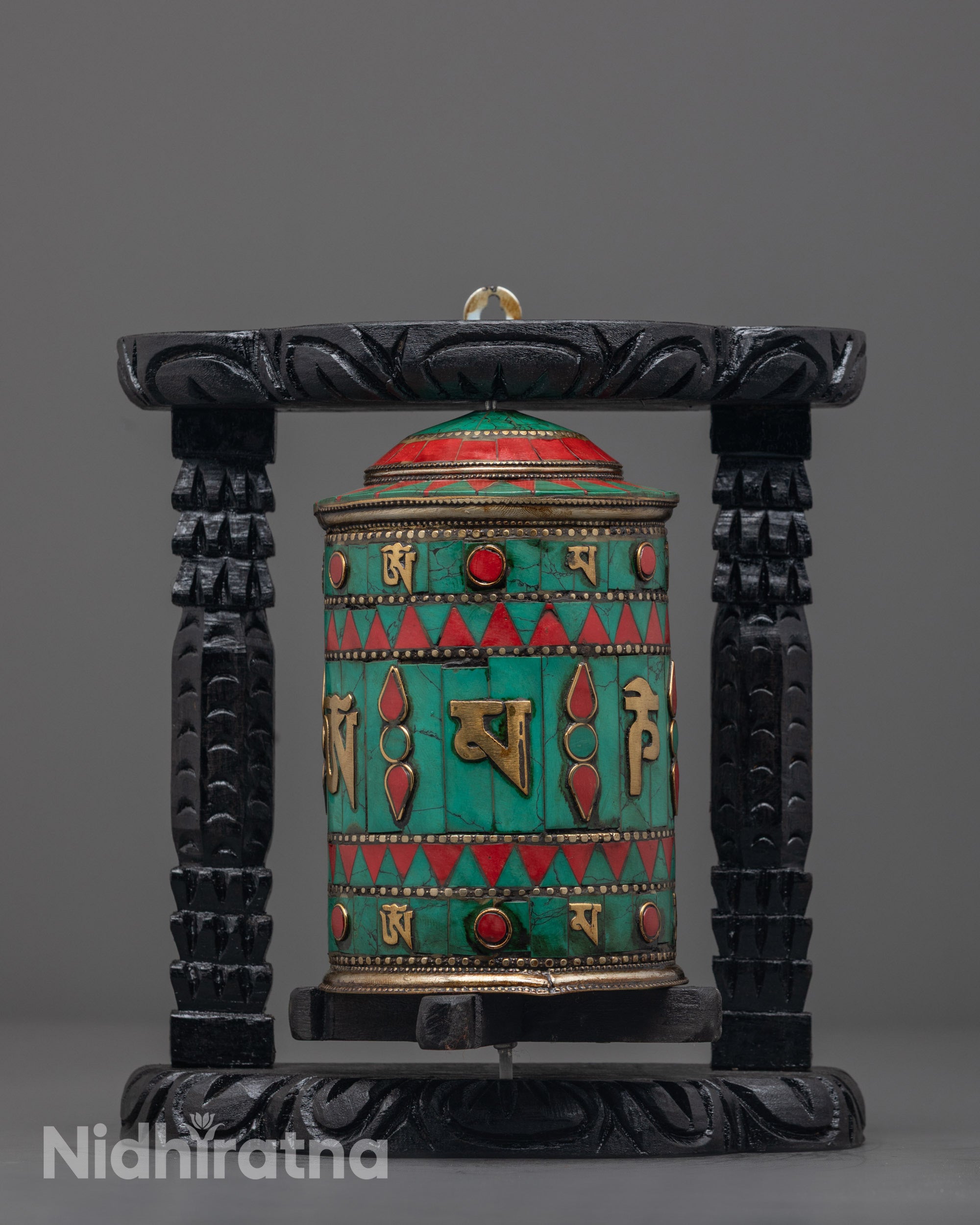 Front view showing the copper wheel and engraved mantras clearly