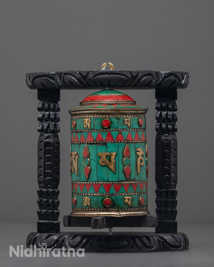 Front view showing the copper wheel and engraved mantras clearly
