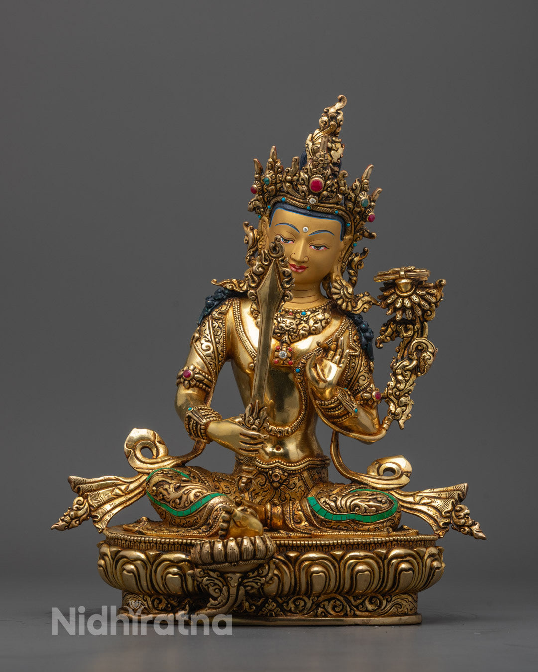 Full View of Seated Manjushri Statue Holding Sword and Wisdom Book on Lotus Base