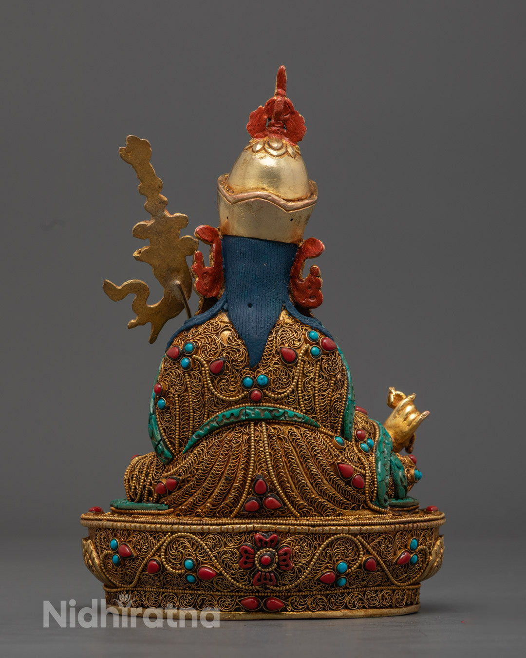 the radiant Guru Rinpoche Statue adorned with semi-precious stones, symbolizing protection and spiritual awakening.