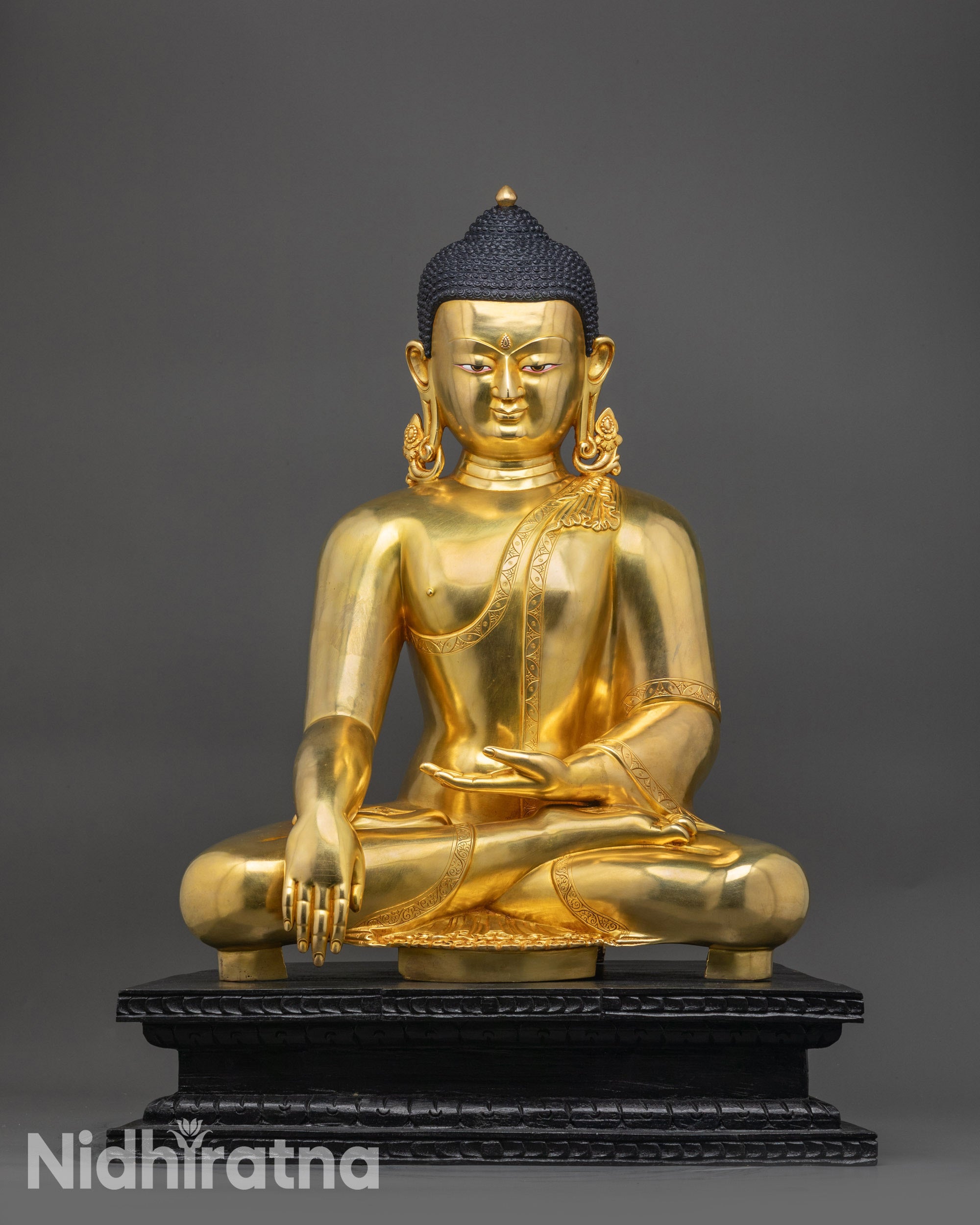 Front view Shakyamuni Buddha statue seated on wooden base, historical enlightened one