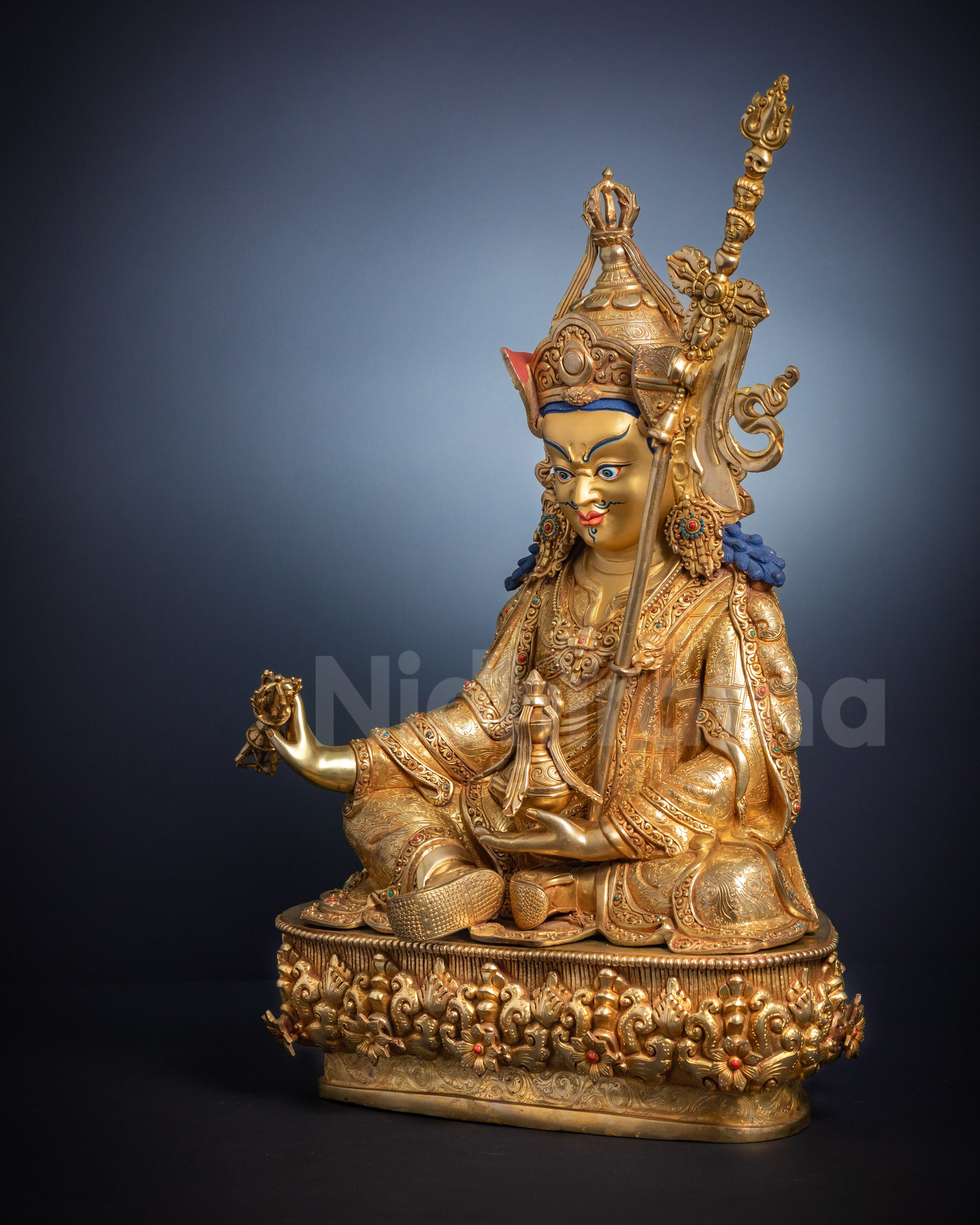 Full side view Guru Rinpoche statue in royal and monastic attire