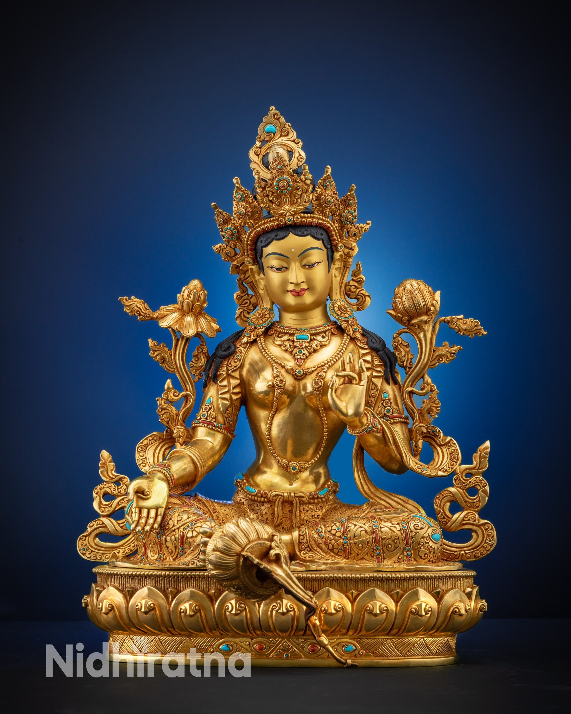 Full view Green Tara statue with gold-gilded face and fire-gilded body
