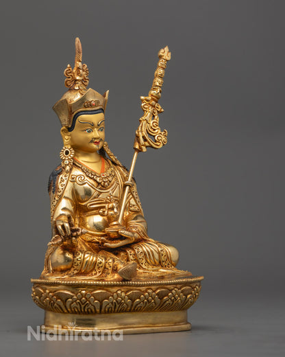 Guru Rinpoche statue seated in meditation posture, with hollow core for mantra filling, decorated with colorful acrylic paint and fire-gilded copper.