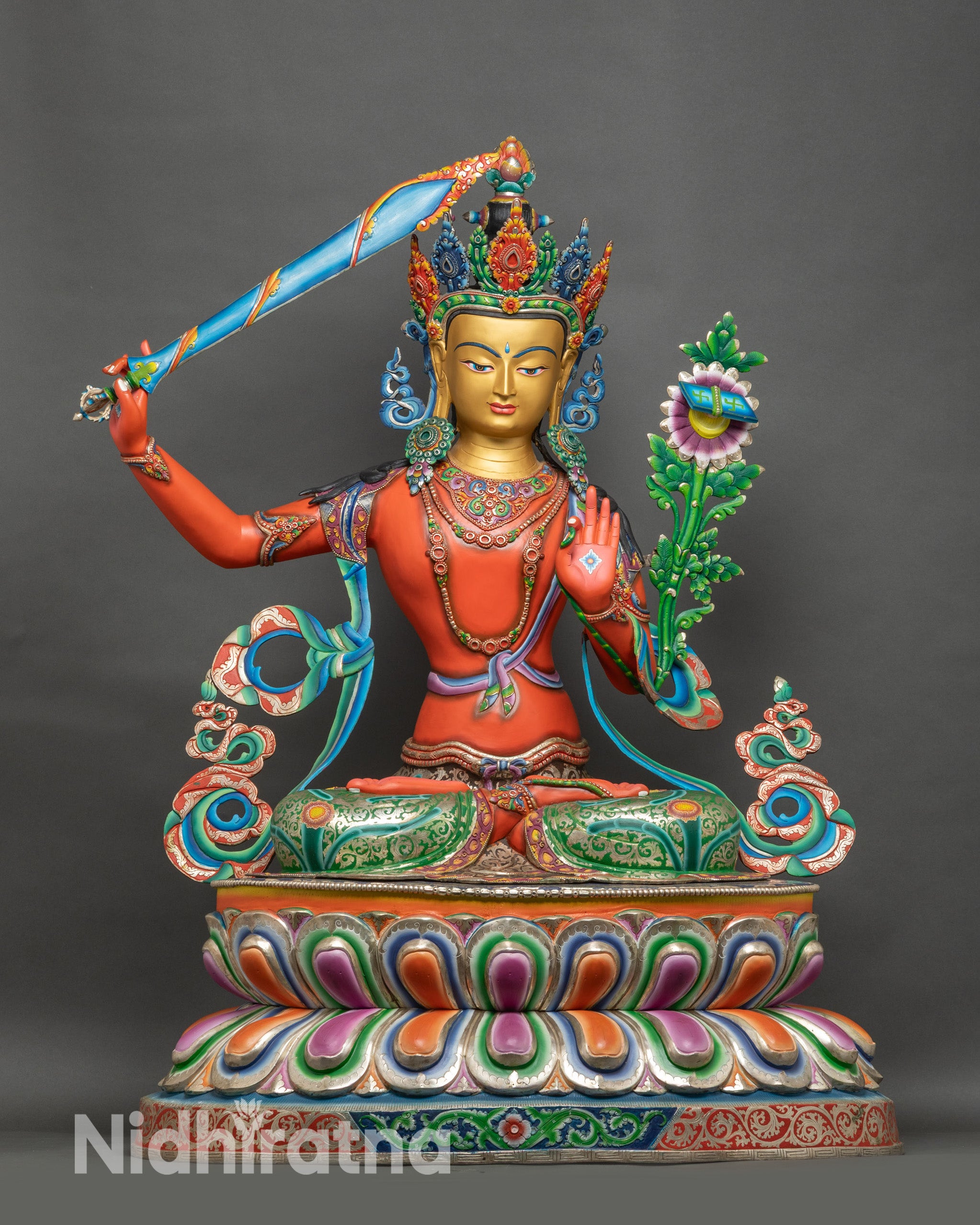 Full view of Manjushri Bodhisattva statue in vibrant colors on a multicolored lotus throne