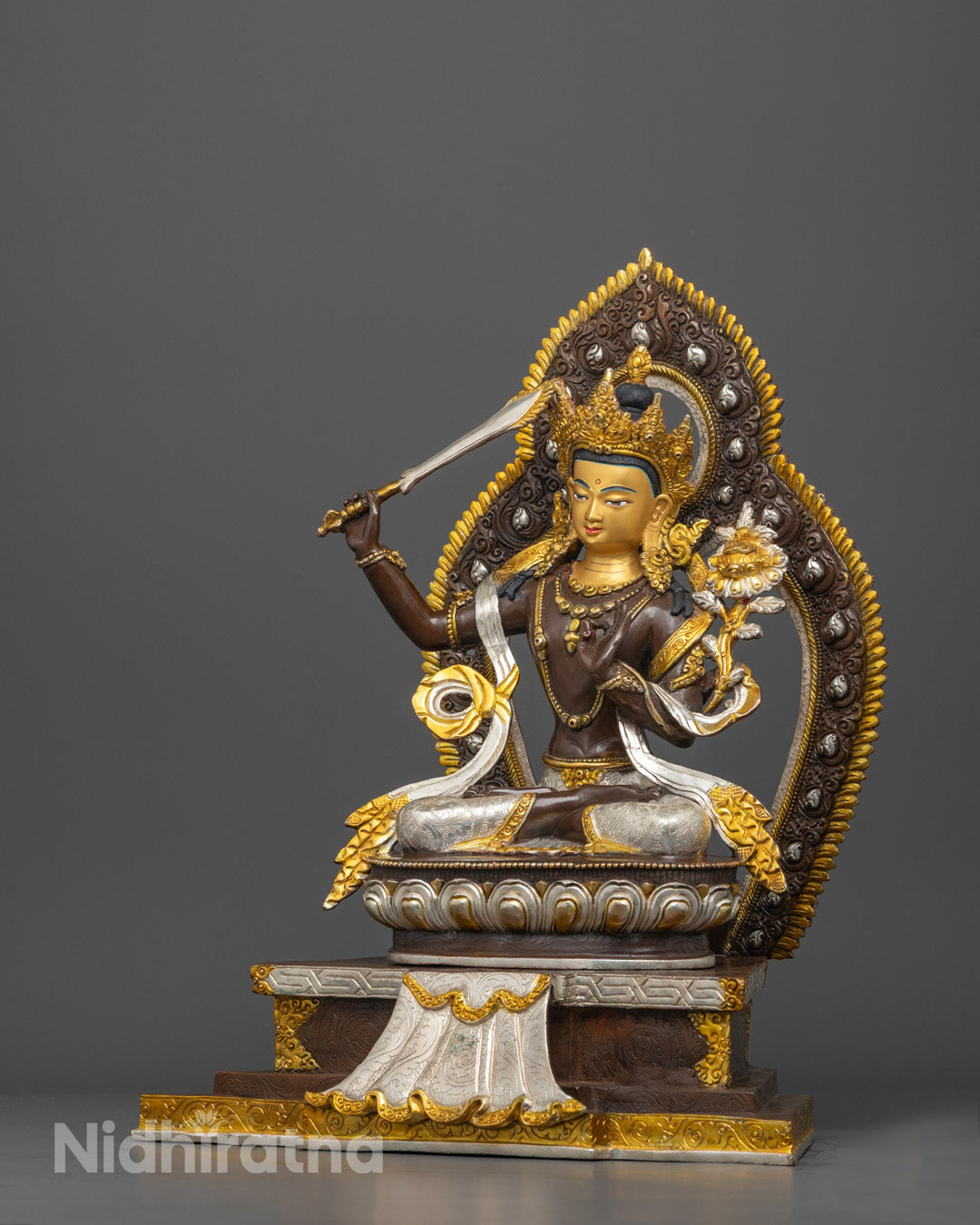 Full view of Manjushri Buddha’s serene face with intricate gold and copper detailing