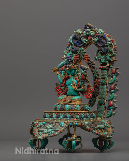 Manjushri statue seated on lotus base, decorated with semi-precious stones and vibrant colors.
