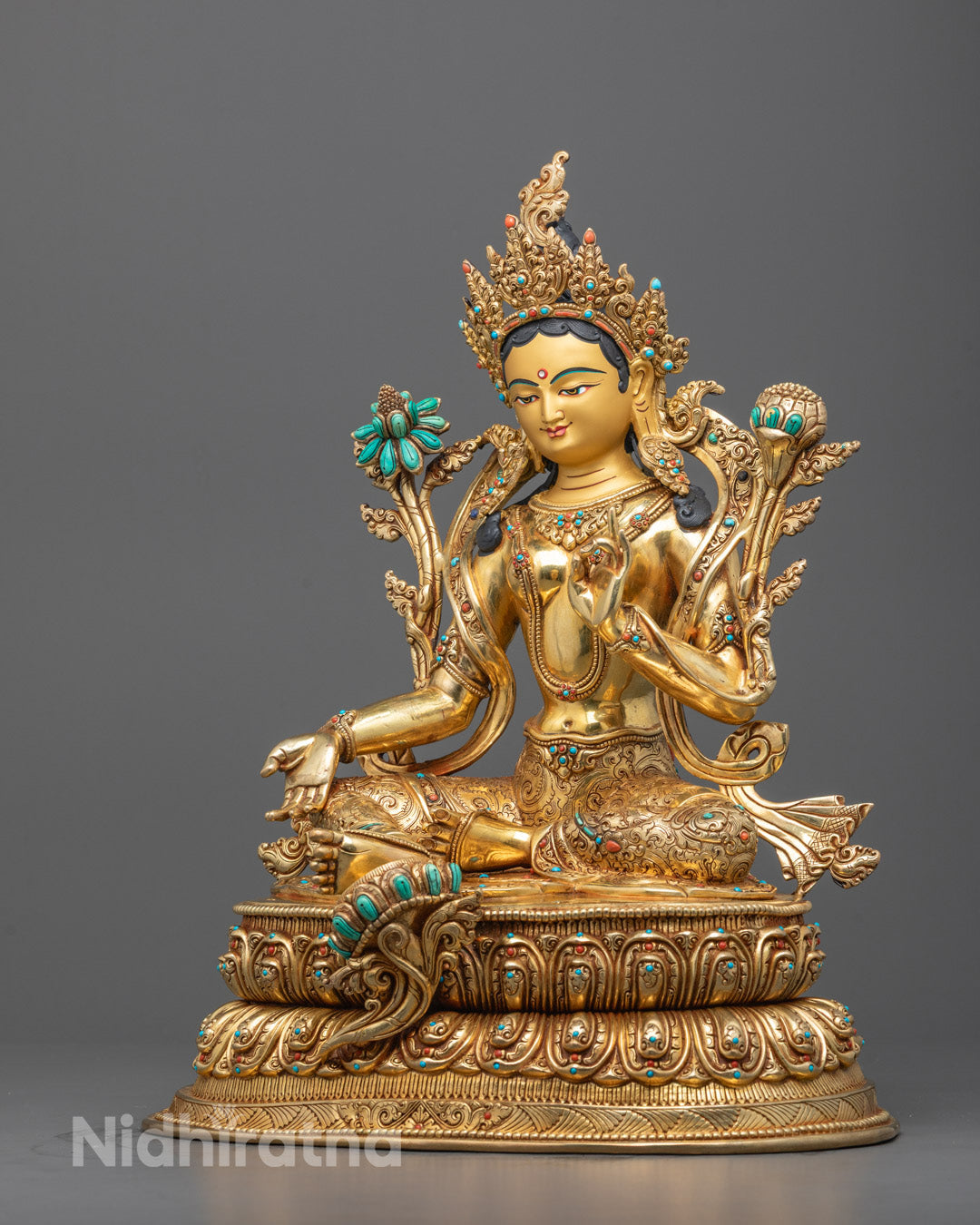 Full view of copper-based Manjushri statue adorned with semi-precious stones