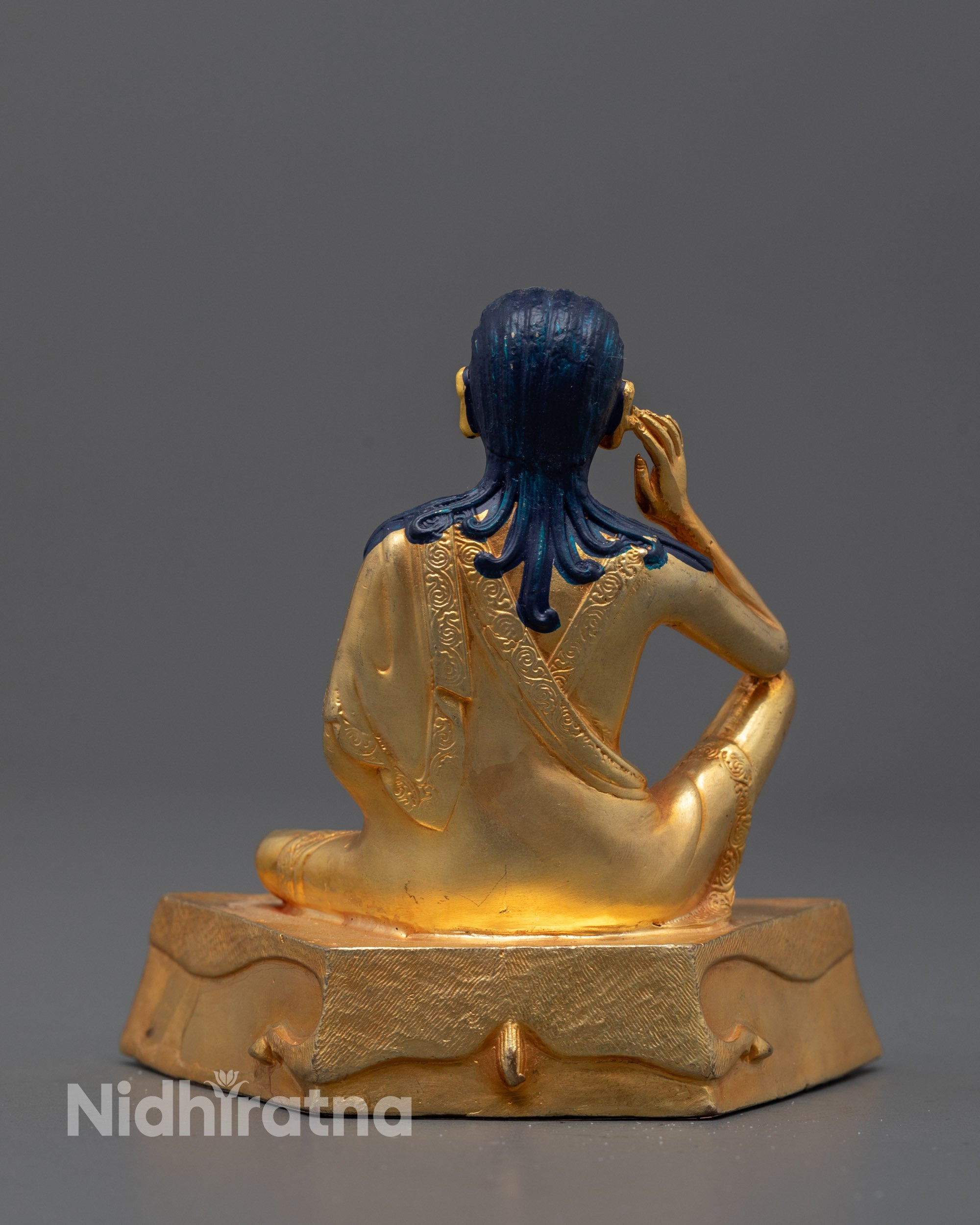 Full view of golden Milarepa Statue displayed on a lotus base symbolizing enlightenment
