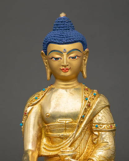 Gautama Buddha Statue close up showing serene gold-gilded face and details