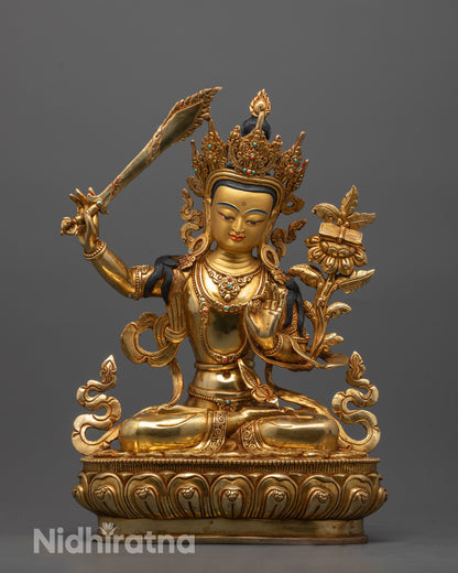 Gold-colored statue of a deity with a weapon on a gray background