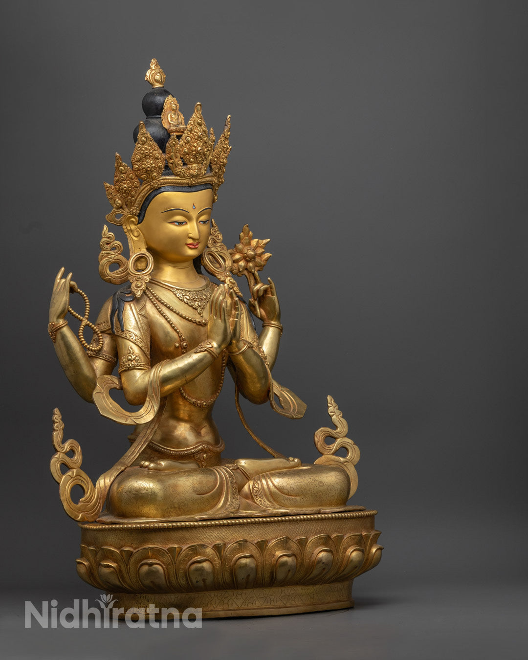 Gold-gilded Chenrezig Avalokiteshvara Buddha statue seated on a lotus throne