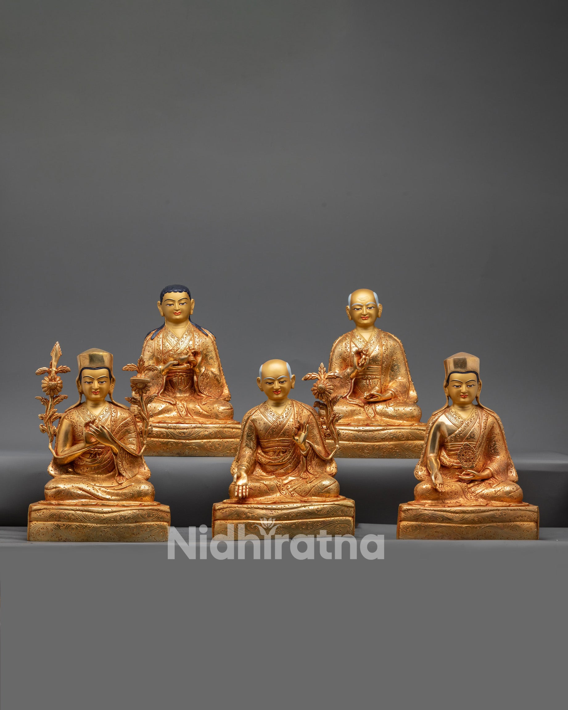 Gold-gilded Sakya masters statue set arranged in a sacred mandala
