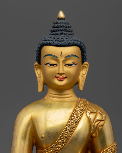 Gold painted face and handcarved monk robe on Shakyamuni Buddha.
