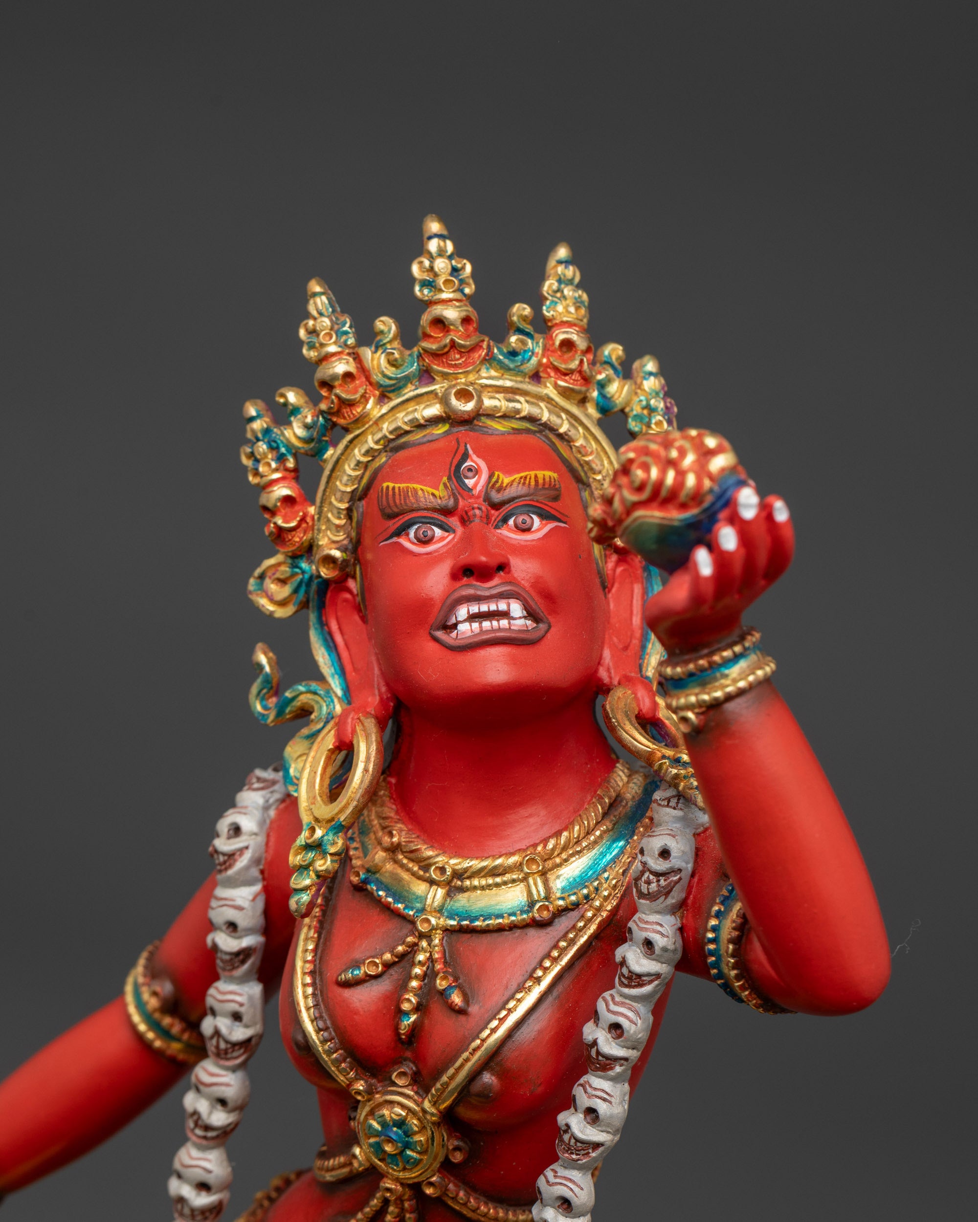 Gold fire gilded halo illuminates the fierce Dakini Vajrayogini deity statue.