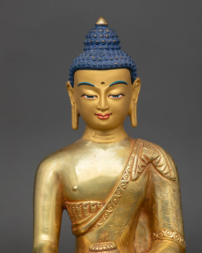 Gold painted face of Shakyamuni Buddha statue with serene meditation expression