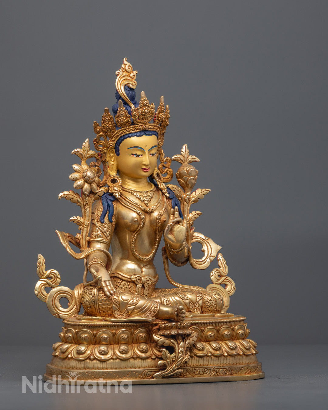 Gracefully seated Mother Tara statue on lotus throne and moon disc symbolizing enlightenment and healing
