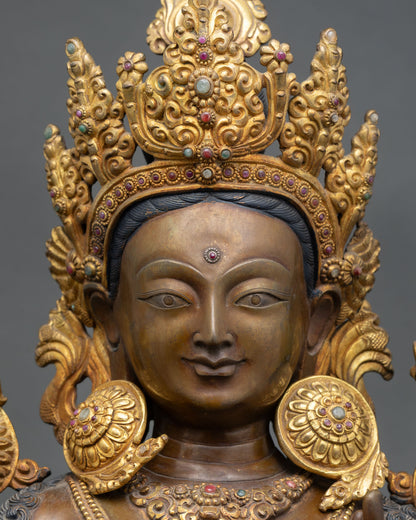 Green Tara face close-up, gold-painted serene expression, compassionate gaze