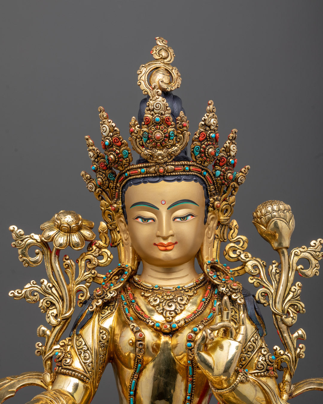 Close-up of Green Tara statue face and crown with 24K gold gilding and fine carvings