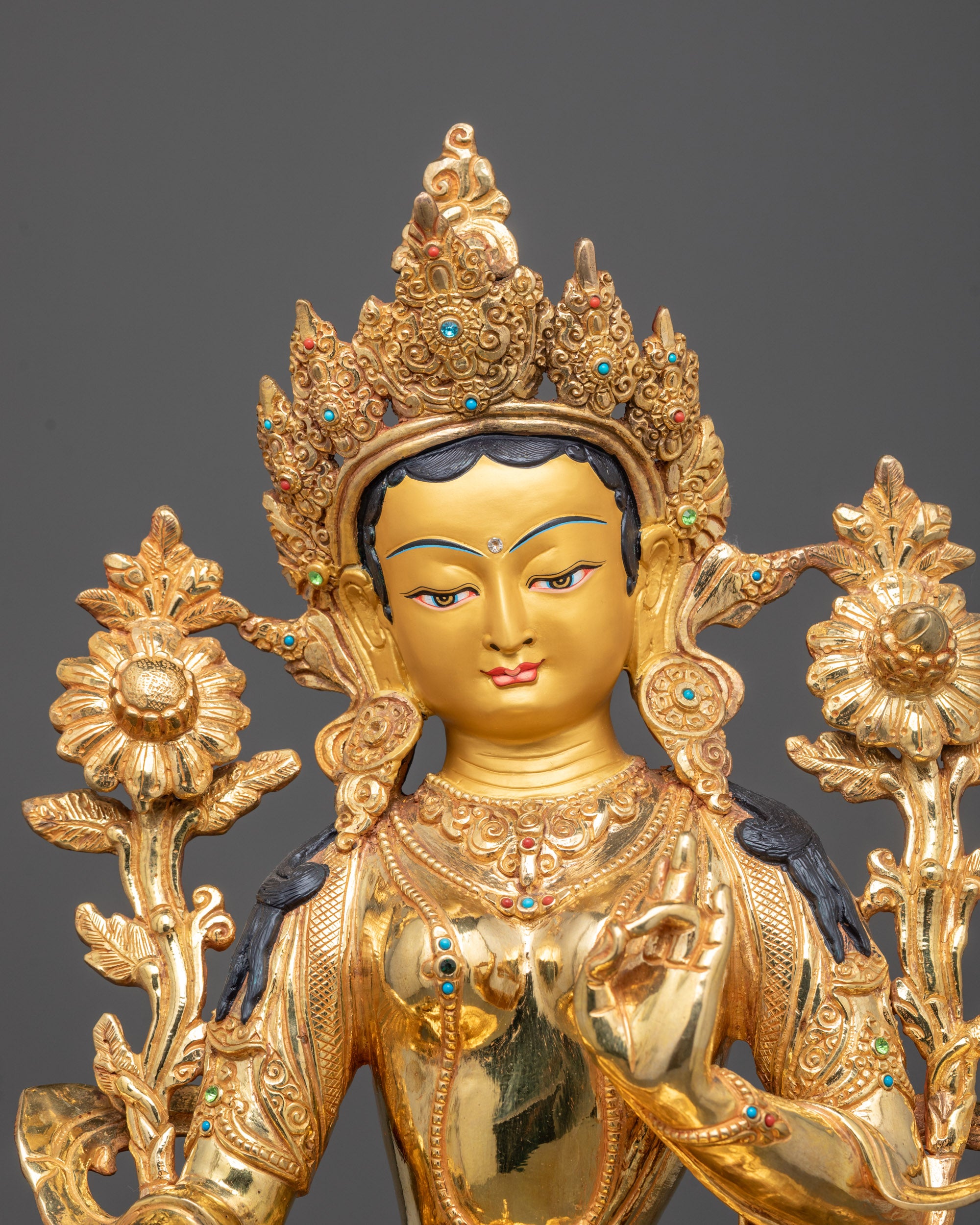 Close-up of Mother Tara Sculpture’s gold-gilded face and intricate carvings from Patan