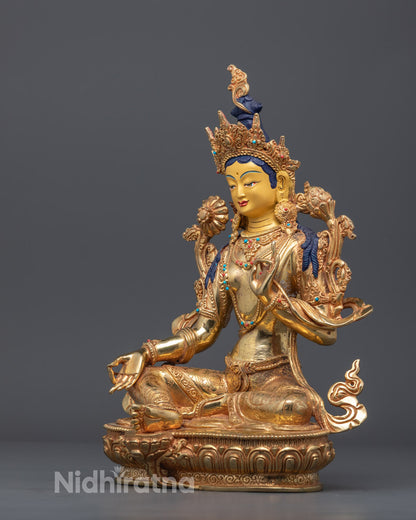 Green Tara seated on lotus throne holding blue utpala flower and displaying Varada Mudra gesture of giving