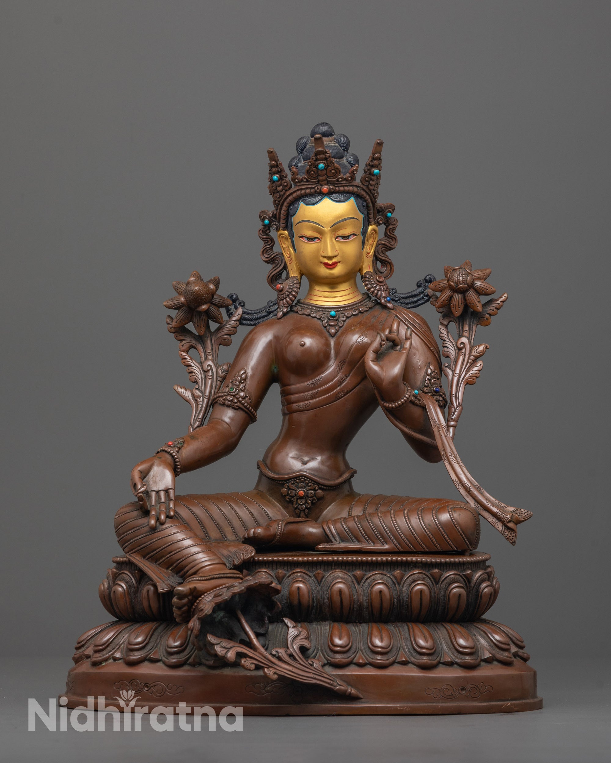 front view of handmade green tara statue with utpala flower and lotus base in oxidized copper