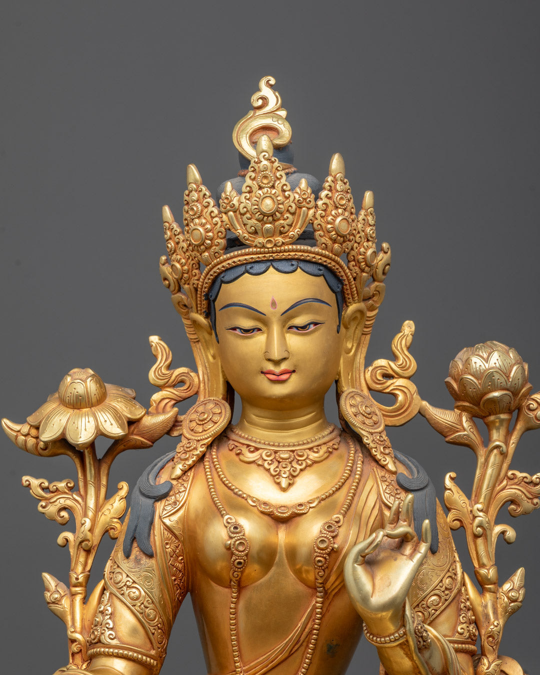 Close-up image of Exquisitely hand-carved Green Tara statue in 24k gold fire gilding, 