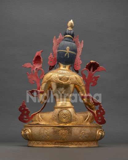 Back view of Green Tara statue with engraved lotus throne, deer and dharma wheel
