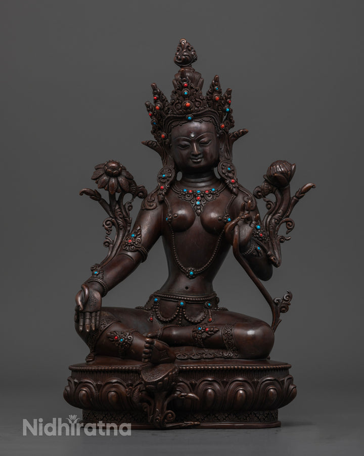 Green Tara statue which is brown and made of oxidized copper