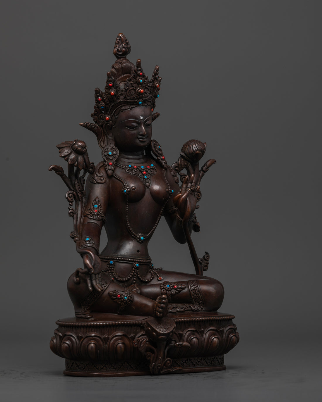 side view of brown oxidized green tara statue