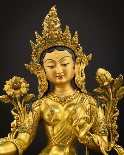 Close-up of Green Tara Buddha statue showing detailed carvings, copper craftsmanship, and polished gold finish