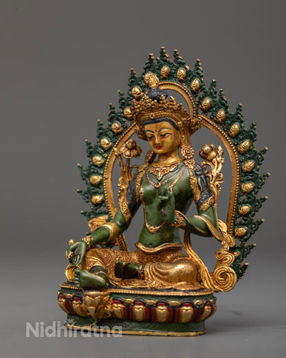 Green Tara Buddhist deity holding uptala flowers with green and gold halo symbolizing purity and protection