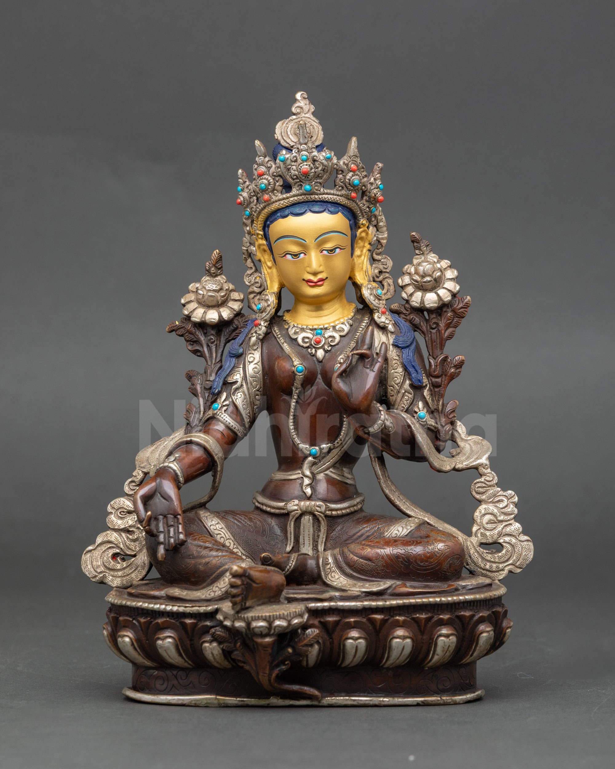 Green Tara Buddhist statue with gold-painted face and oxidized silver-plated body