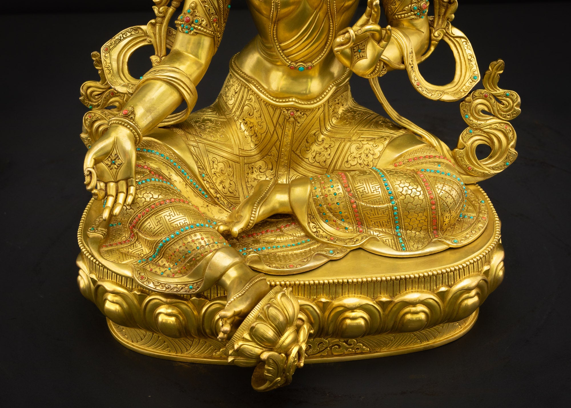 Lower front landscape of Green Tara Himalayan statue highlighting lotus pedestal, Lalitasana posture, and base details