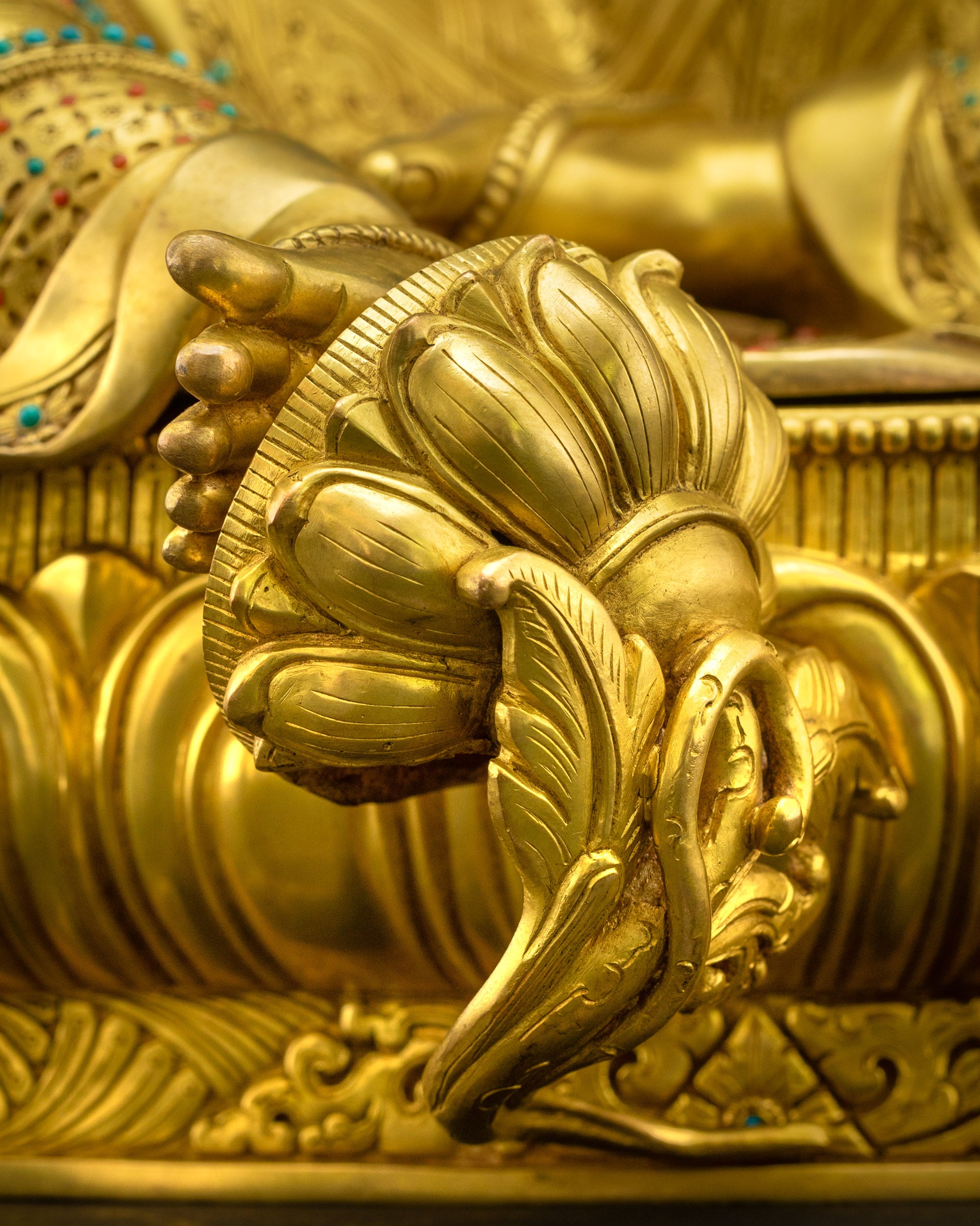 Green Tara statue seated in Lalitasana on lotus pedestal, right leg extended, symbol of swift compassion