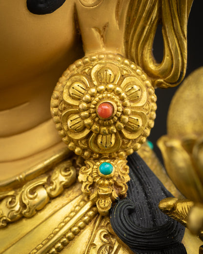 Green Tara statue adorned with semi-precious stones and radiant fire-gilded gold finish