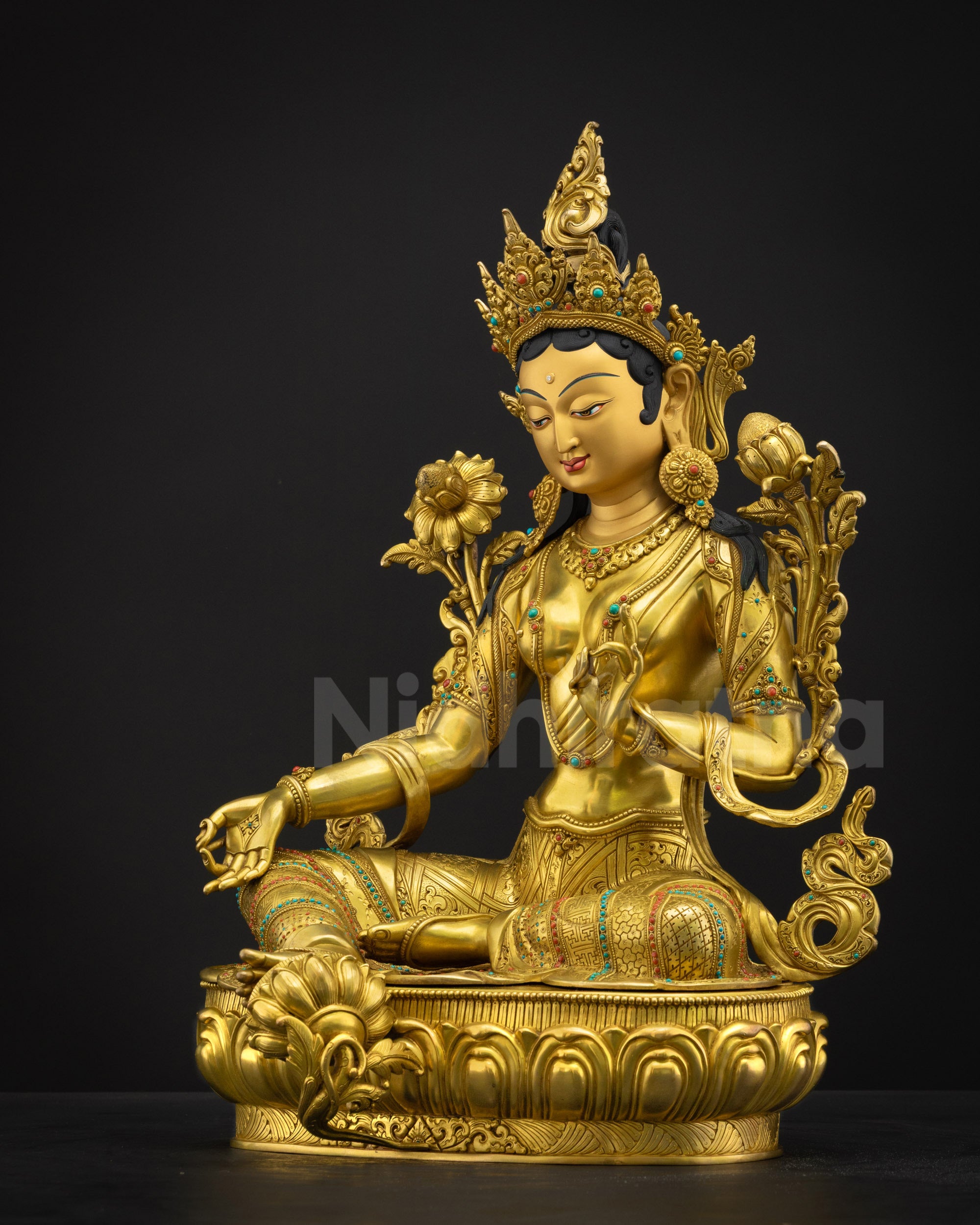 Left-side view of Green Tara statue, left leg tucked, hand gestures in Abhaya and Varada Mudra