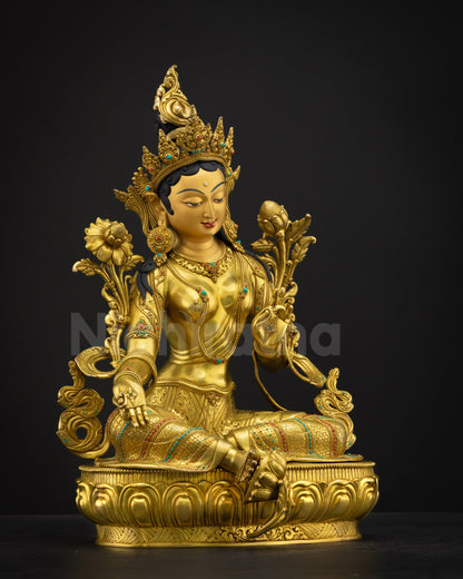 Right-side view of Green Tara statue in Lalitasana, right leg extended, holding utpala lotus