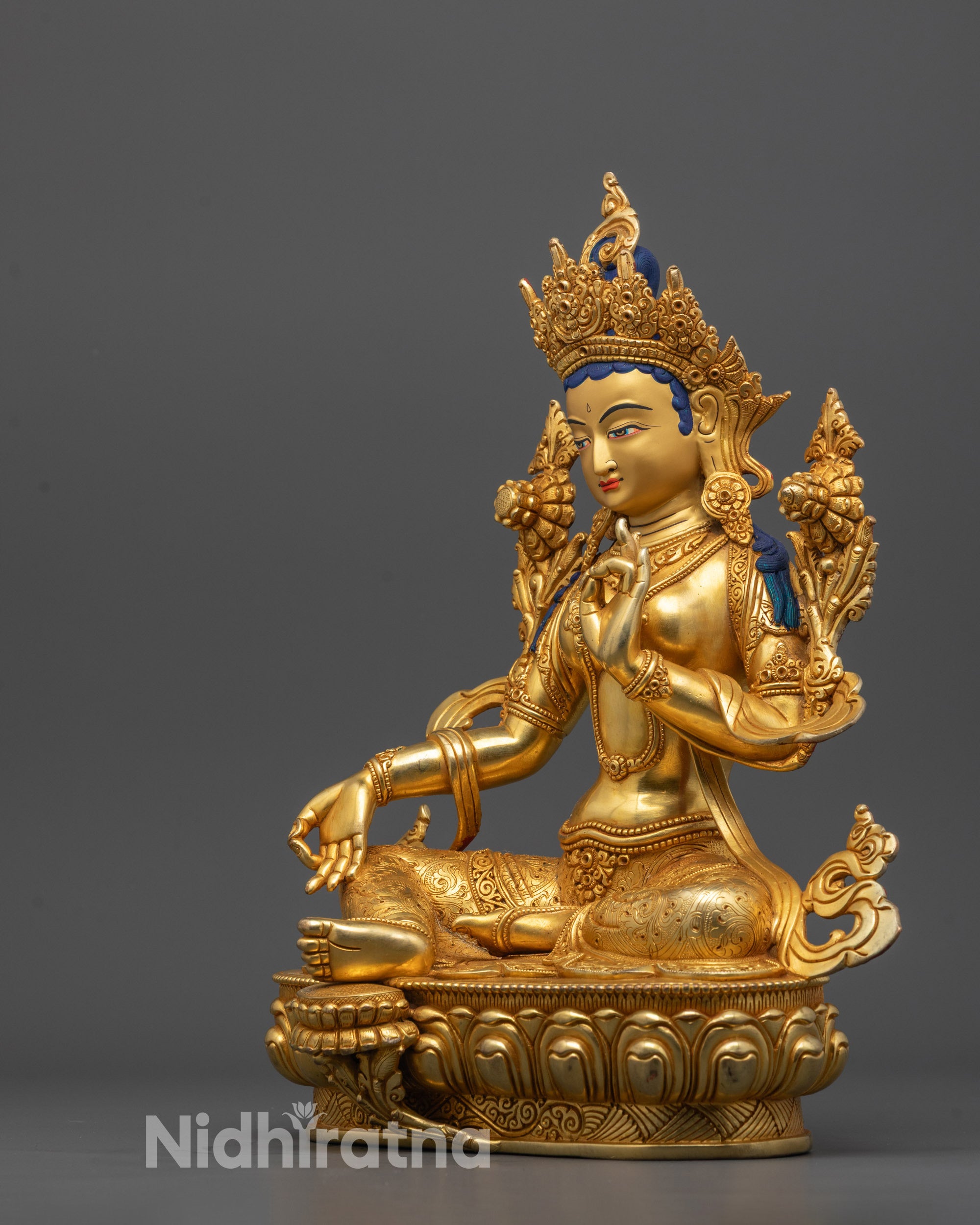 Green Tara Statue displayed on spiritual altar with soft lighting highlighting gold finish