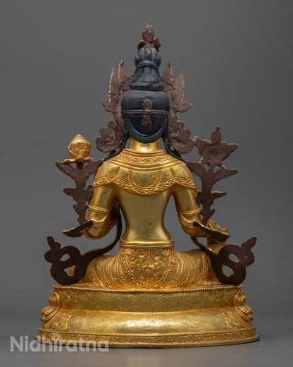 Green Tara Statue holding a blue lotus, symbolizing purity and compassion, adorned with semi-precious stones.