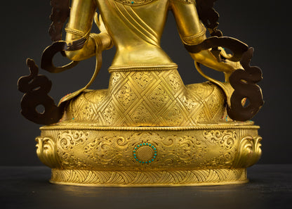 Lower back landscape view of Green Tara Tibetan statue showing intricate carvings and fire-gilded gold finish