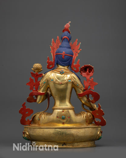 Green Tara back view displaying floral and patterned garments carved with precision